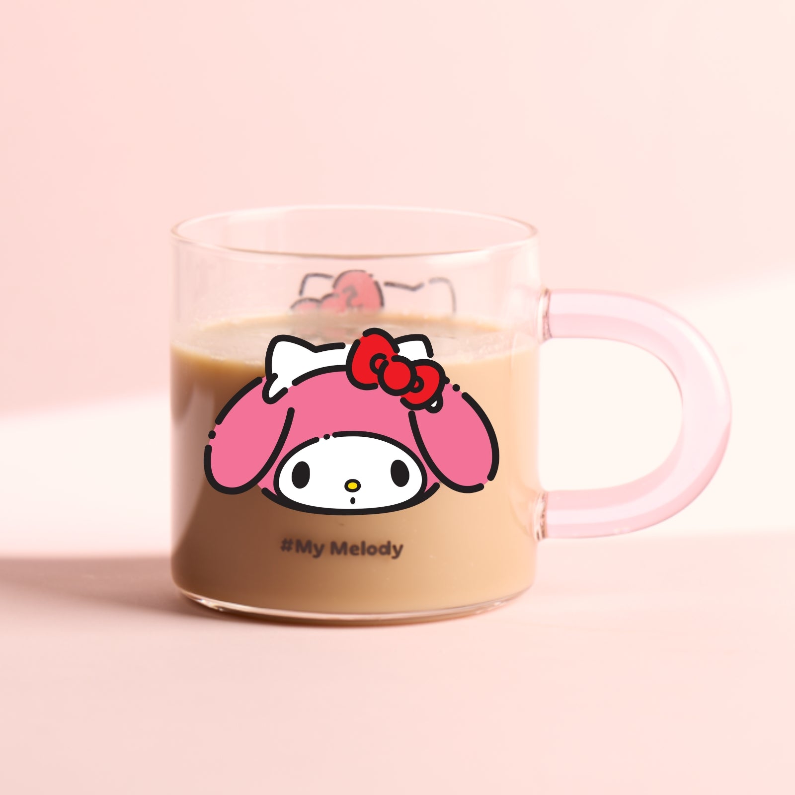 A glass mug with a Hello Kitty character design featuring a red bow on the front, complete with a blue handle.